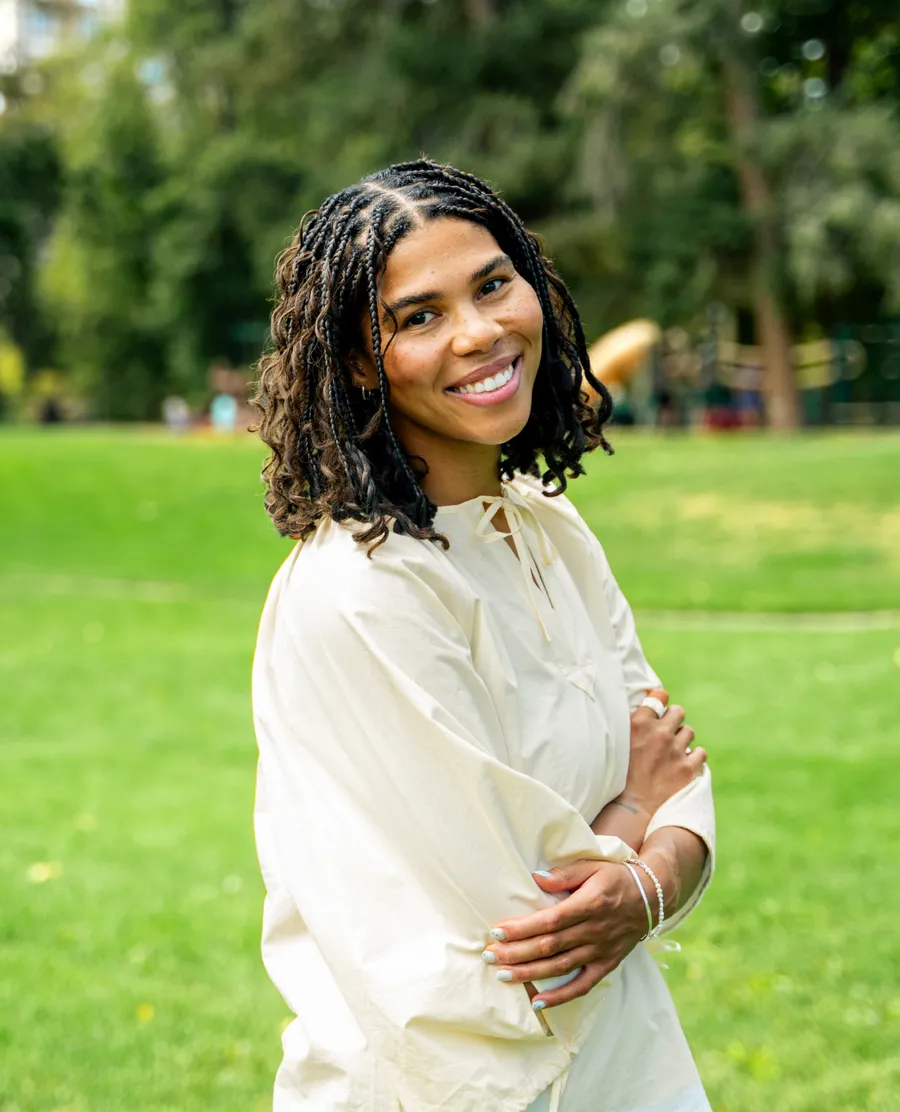 Patrece Hodge, founder of Three Peas in a Pod, standing in a sunny Denver park